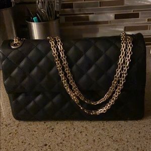Black quilted handbag with gold chain hardware